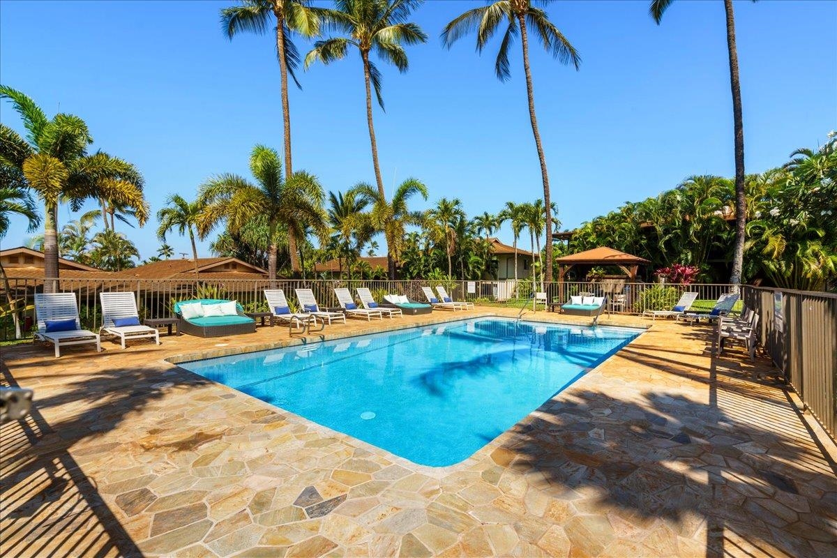 3788 Lower Honoapiilani Road, Unit A114 Lahaina, HI 96761 - Photo 4 of 18 a view of a swimming pool with a lawn chairs under an umbrella