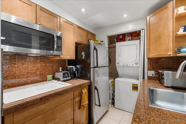 a kitchen with stainless steel appliances a microwave a sink and cabinets
