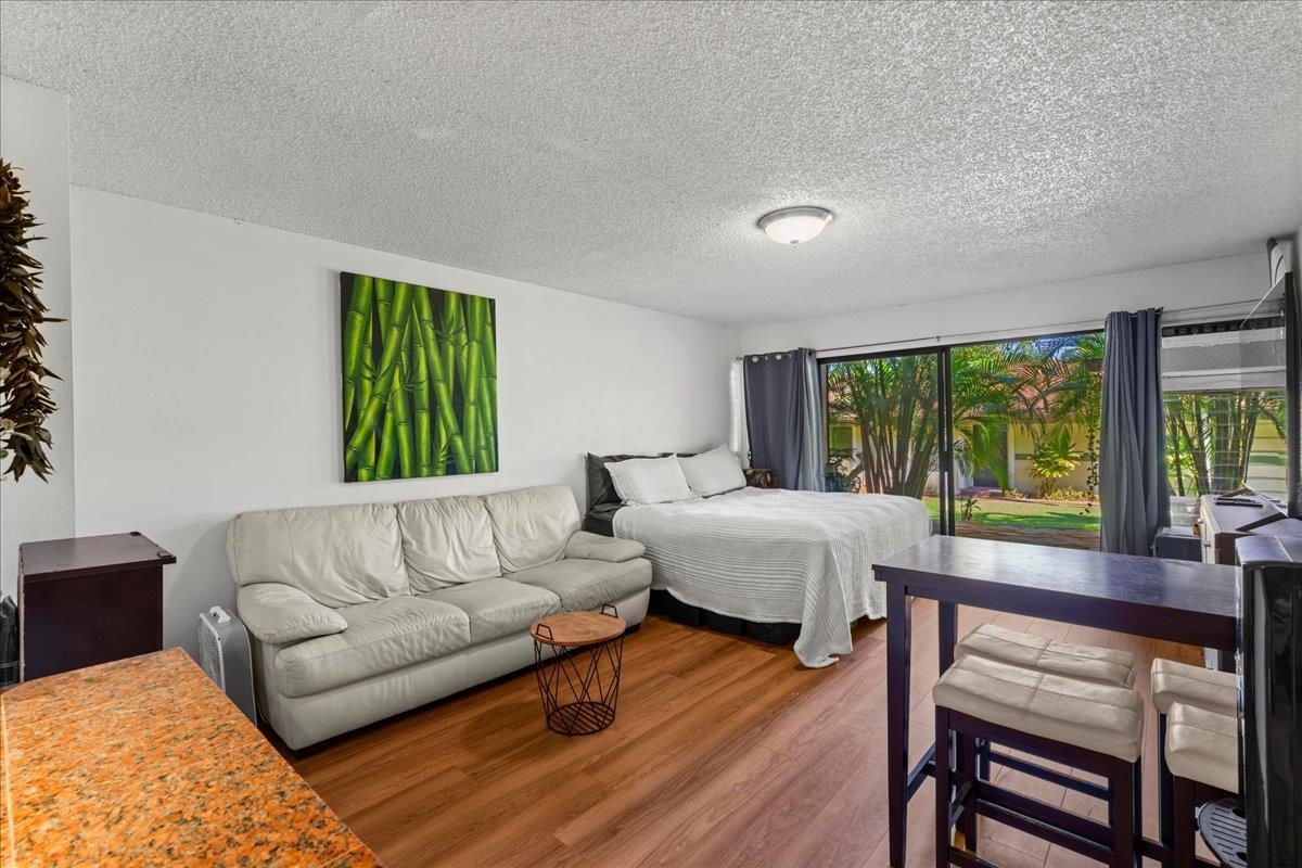 3788 Lower Honoapiilani Road, Unit A114 Lahaina, HI 96761 - Photo 8 of 18 a living room with furniture and a large window