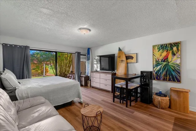 a bedroom with furniture and a flat screen tv