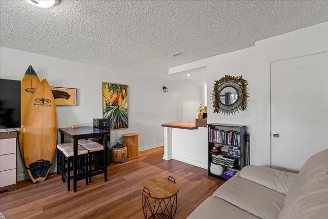 a living room with furniture and a mirror