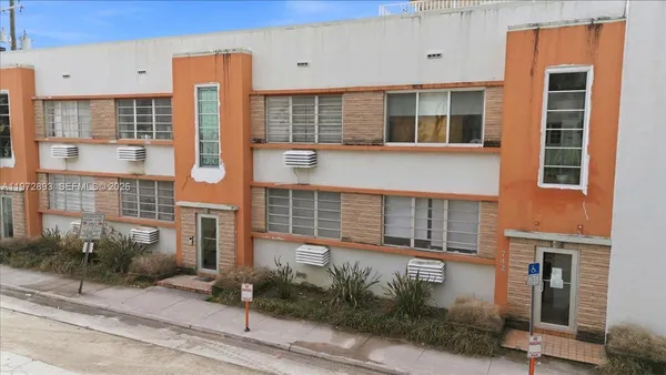 a front view of a building with a garden