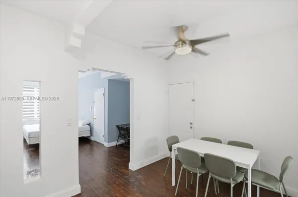 a view of a dining room with furniture and wooden floor