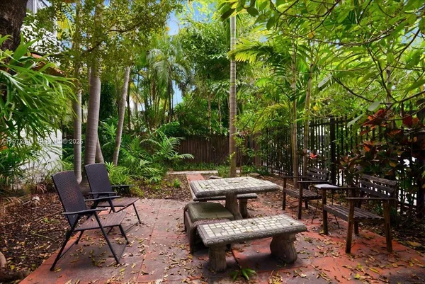 a view of a patio with table and chairs and potted plants