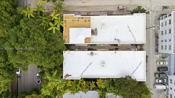 an aerial view of a house with a yard