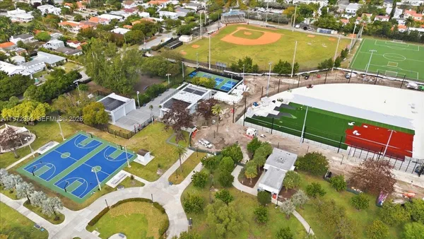an aerial view of a house with a swimming pool yard and mountain view in back