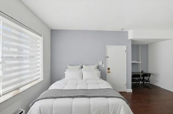 a bedroom with a bed and a chair