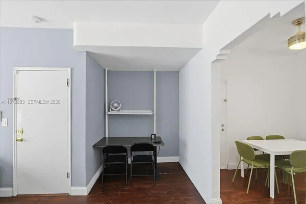 a view of room with furniture and wooden floor