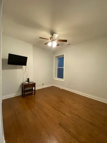a view of a livingroom with chairs and a ceiling fan