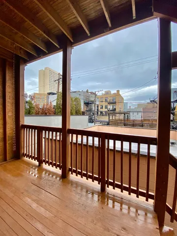 a view of a balcony with wooden floor