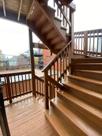 a view of staircase with wooden floor and white walls