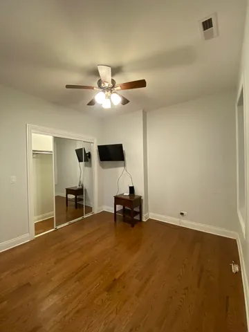 a view of a workspace with furniture and a ceiling fan