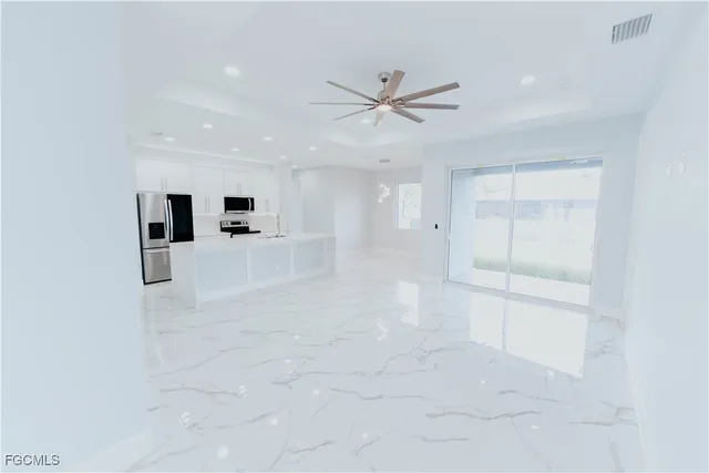 a view of a livingroom with a ceiling fan and window
