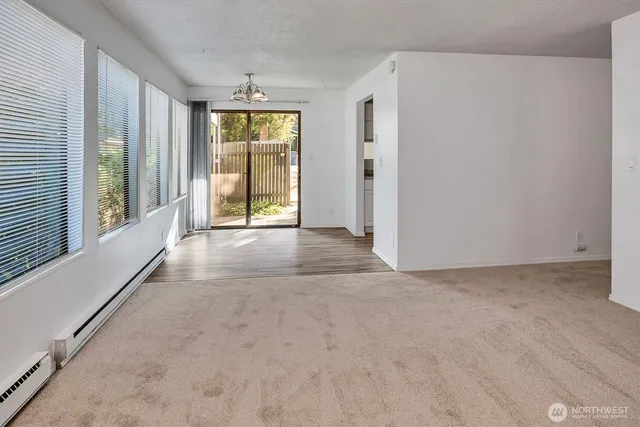 a view of an empty room with glass door