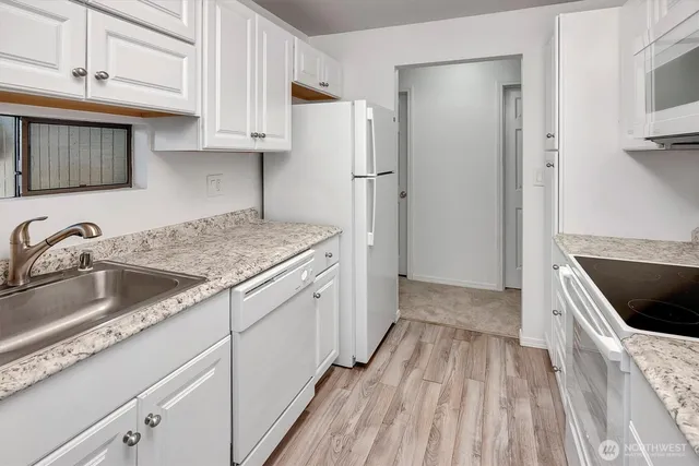 a kitchen with a sink stove and refrigerator