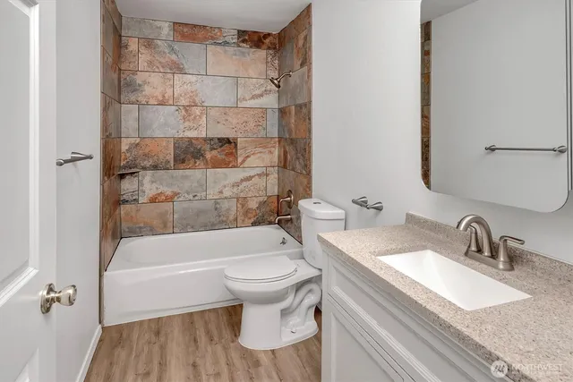 a bathroom with a sink a toilet and bathtub