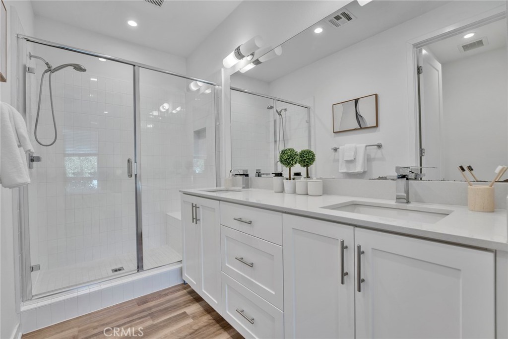 105 Schick Irvine, CA 92614 - Photo 17 of 39 a bathroom with a double vanity sink mirror and shower