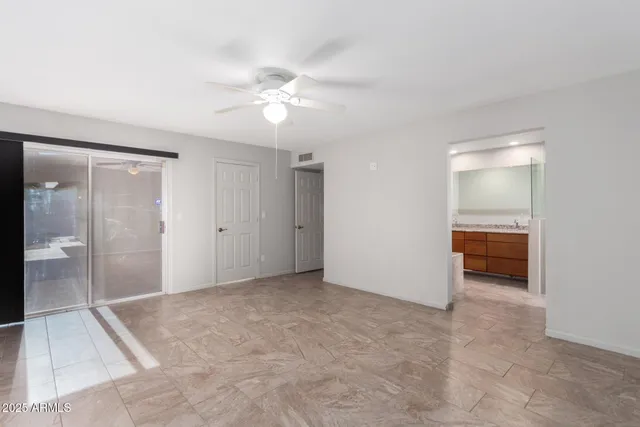 wooden floor in an empty room and a bathroom