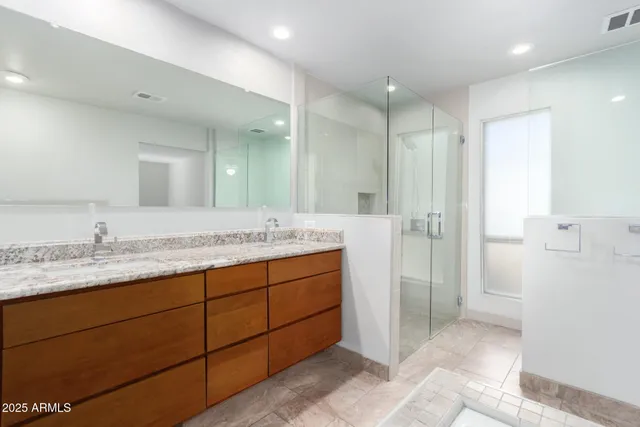 a bathroom with a granite countertop sink mirror and double