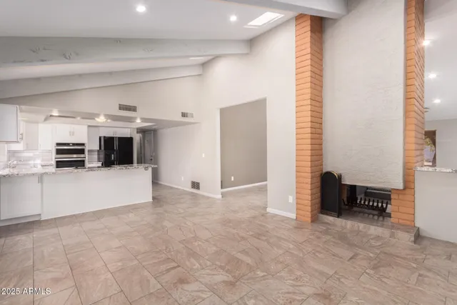 a view of kitchen with furniture and a refrigerator