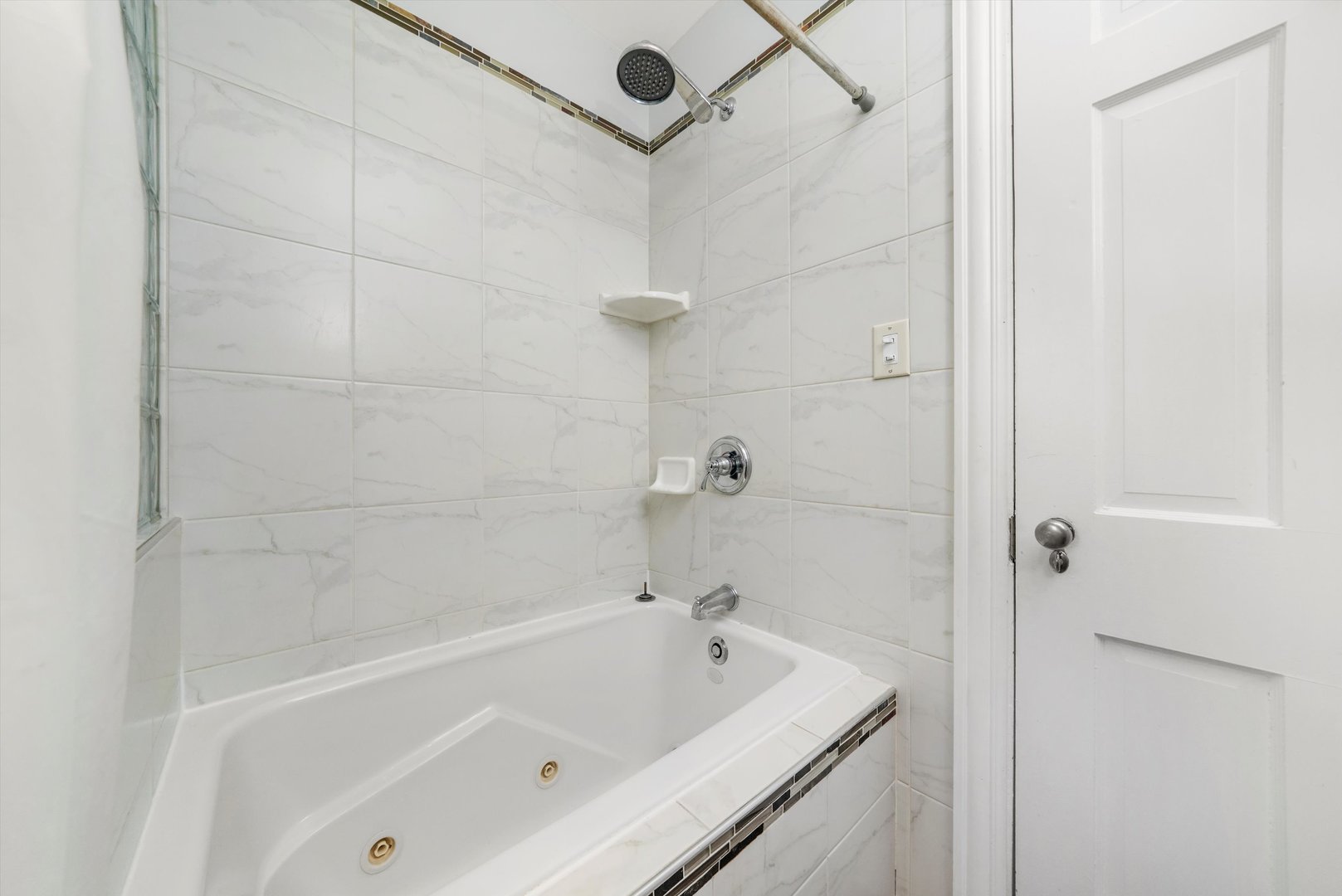 2108 Harrison Street Evanston, IL 60201 - Photo 12 of 44 a bathroom with a bathtub and shower
