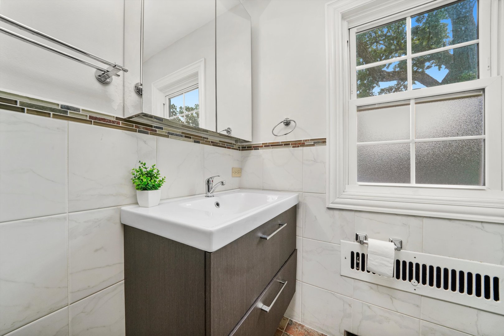 2108 Harrison Street Evanston, IL 60201 - Photo 13 of 44 a bathroom with a sink and a mirror