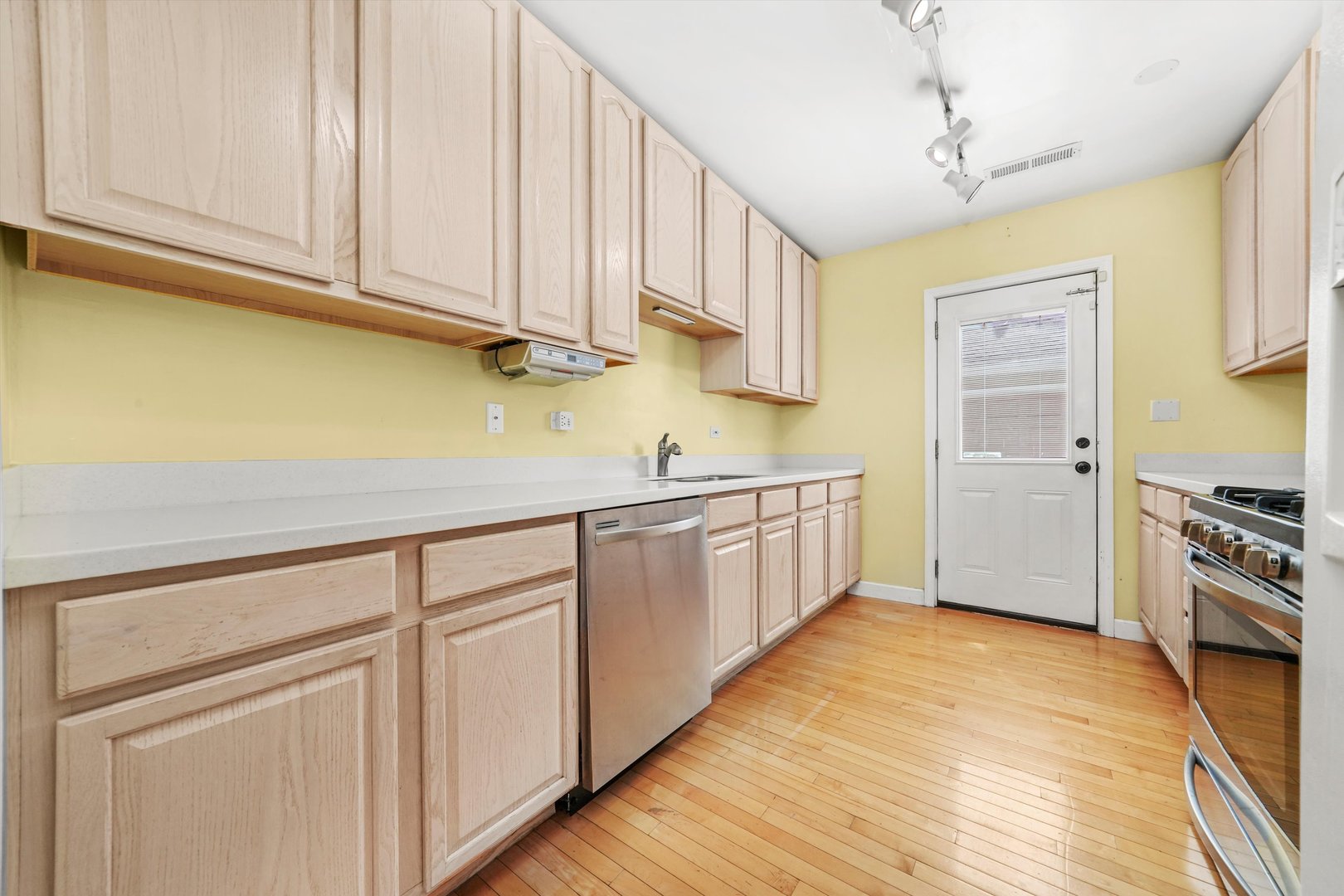 2108 Harrison Street Evanston, IL 60201 - Photo 31 of 44 a kitchen with stainless steel appliances granite countertop a sink and cabinets