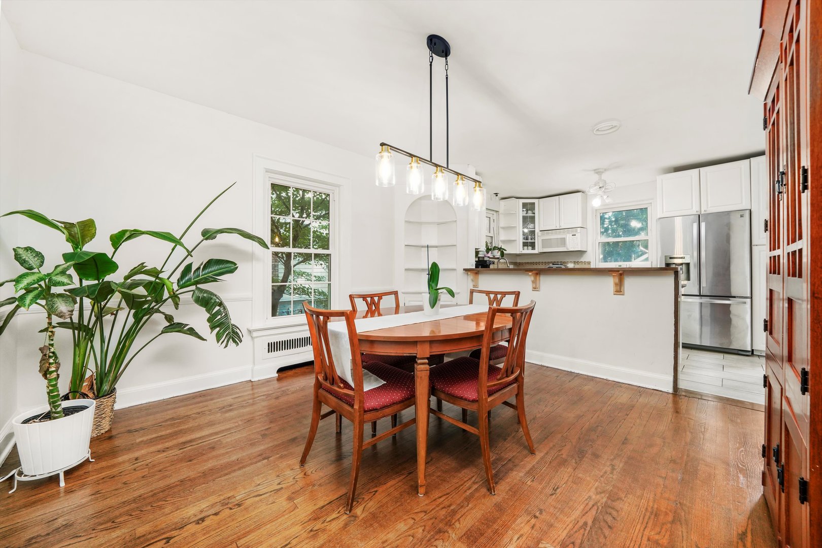 2108 Harrison Street Evanston, IL 60201 - Photo 5 of 44 a dining room with furniture potted plants and wooden floor