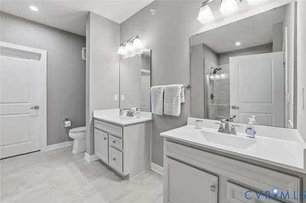 a bathroom with a double vanity sink and a mirror