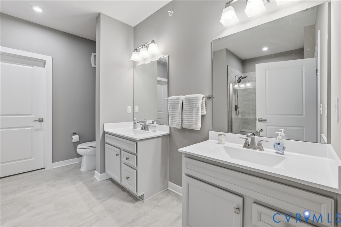 6635 Citory Way, Unit 306 Moseley, VA 23120 - Photo 11 of 16 a bathroom with a double vanity sink and a mirror