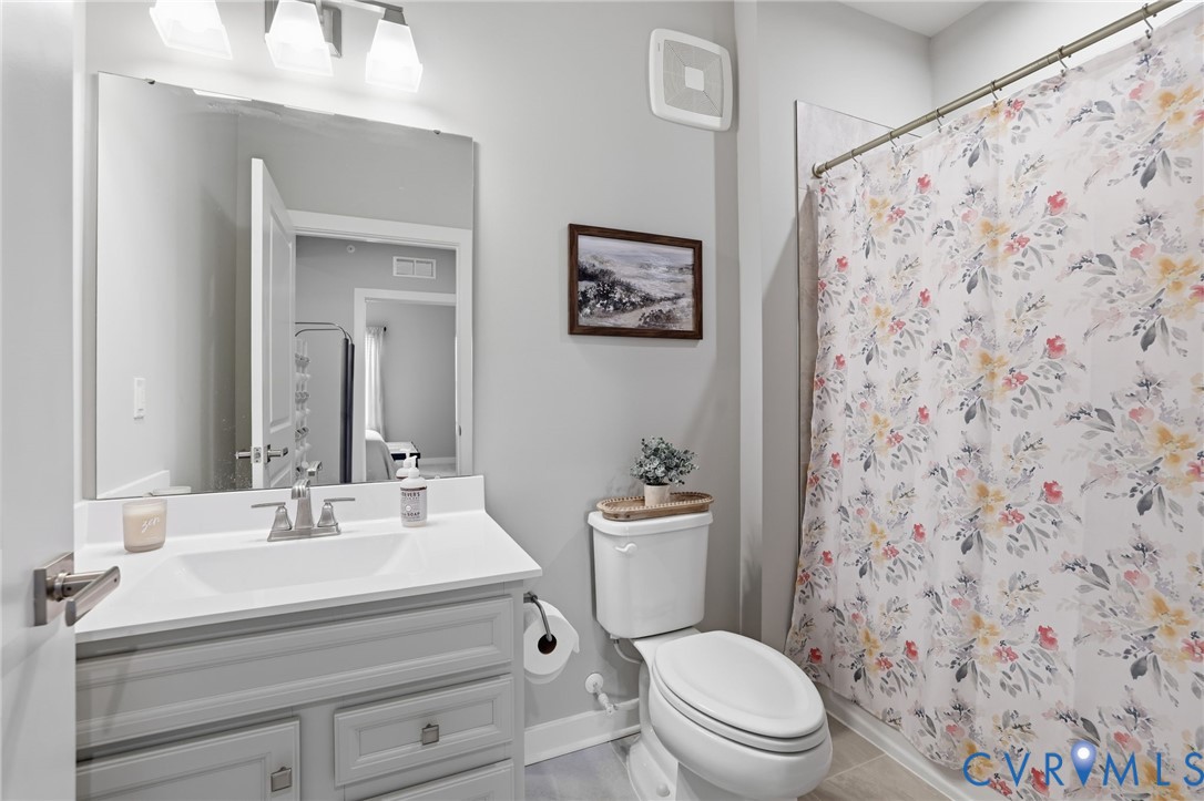6635 Citory Way, Unit 306 Moseley, VA 23120 - Photo 8 of 16 a bathroom with a sink a toilet and a mirror