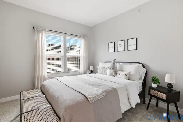 a bedroom with a bed and a lamp on table