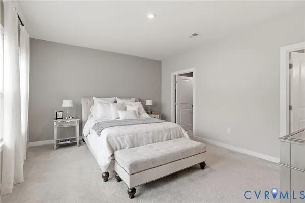 a bedroom with a bed and a couch