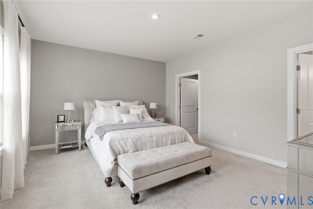 6635 Citory Way, Unit 306 Moseley, VA 23120 - Photo 10 of 16 a bedroom with a bed and a couch