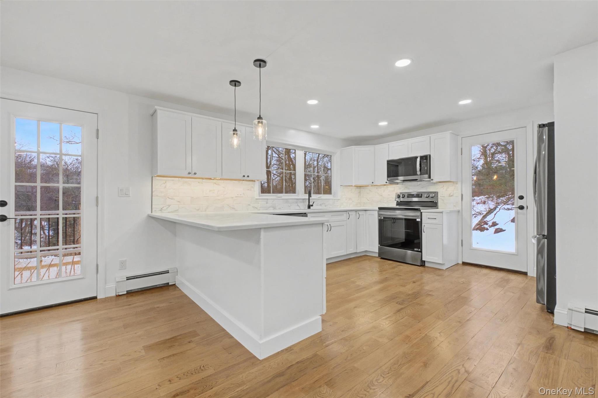 16 Cold Spring Road Putnam Valley, NY 10579 - Photo 11 of 44 a kitchen with white cabinets and appliances