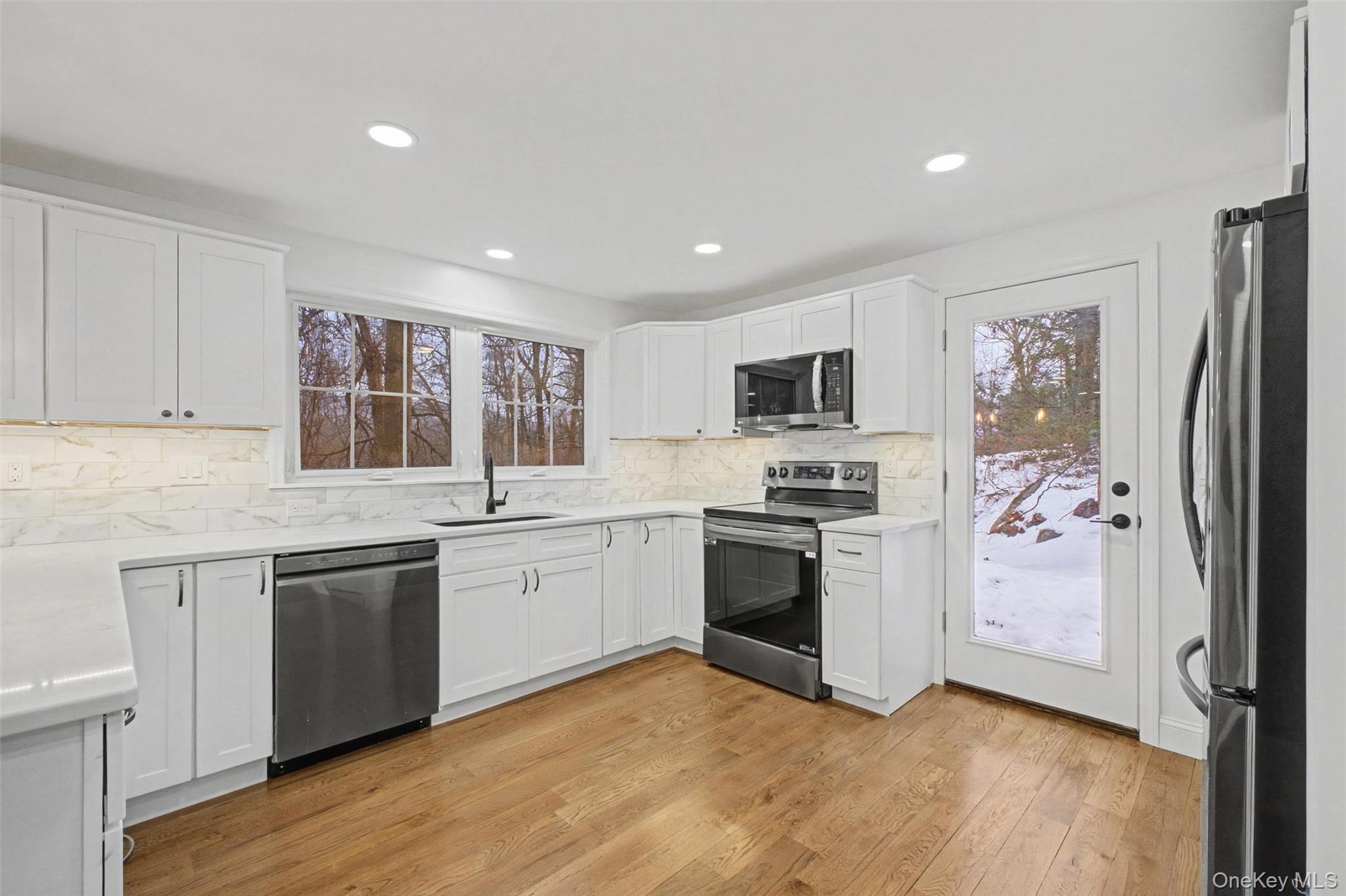 16 Cold Spring Road Putnam Valley, NY 10579 - Photo 12 of 44 a kitchen with granite countertop stainless steel appliances a sink and a refrigerator