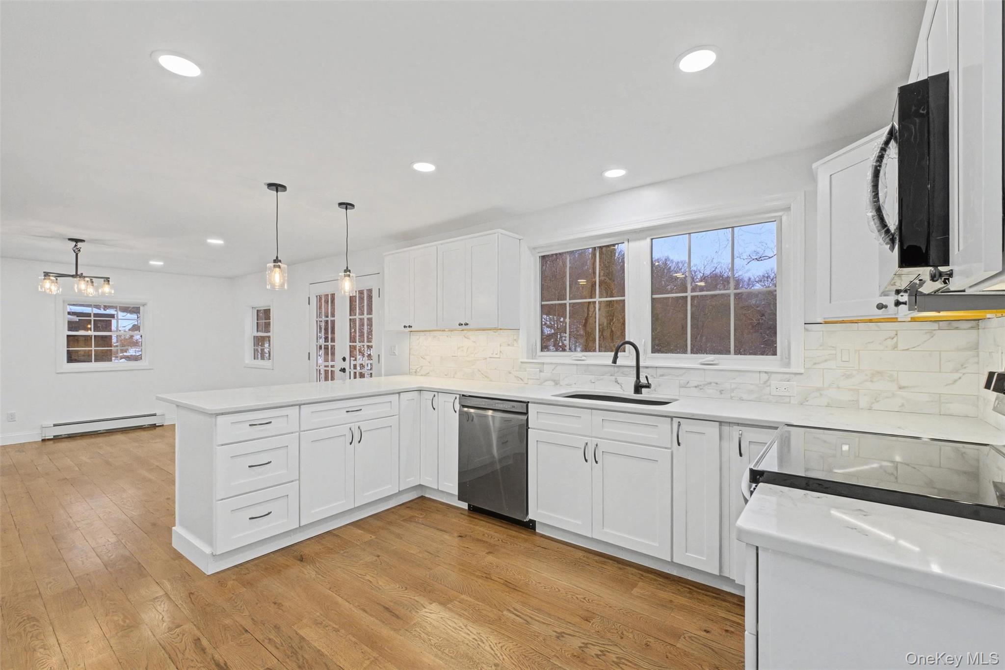 16 Cold Spring Road Putnam Valley, NY 10579 - Photo 15 of 44 a large kitchen with stainless steel appliances granite countertop a sink and dishwasher with wooden floor