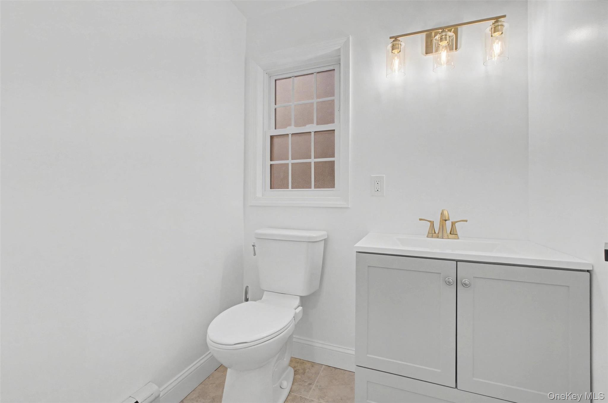 16 Cold Spring Road Putnam Valley, NY 10579 - Photo 16 of 44 a bathroom with a toilet sink and vanity