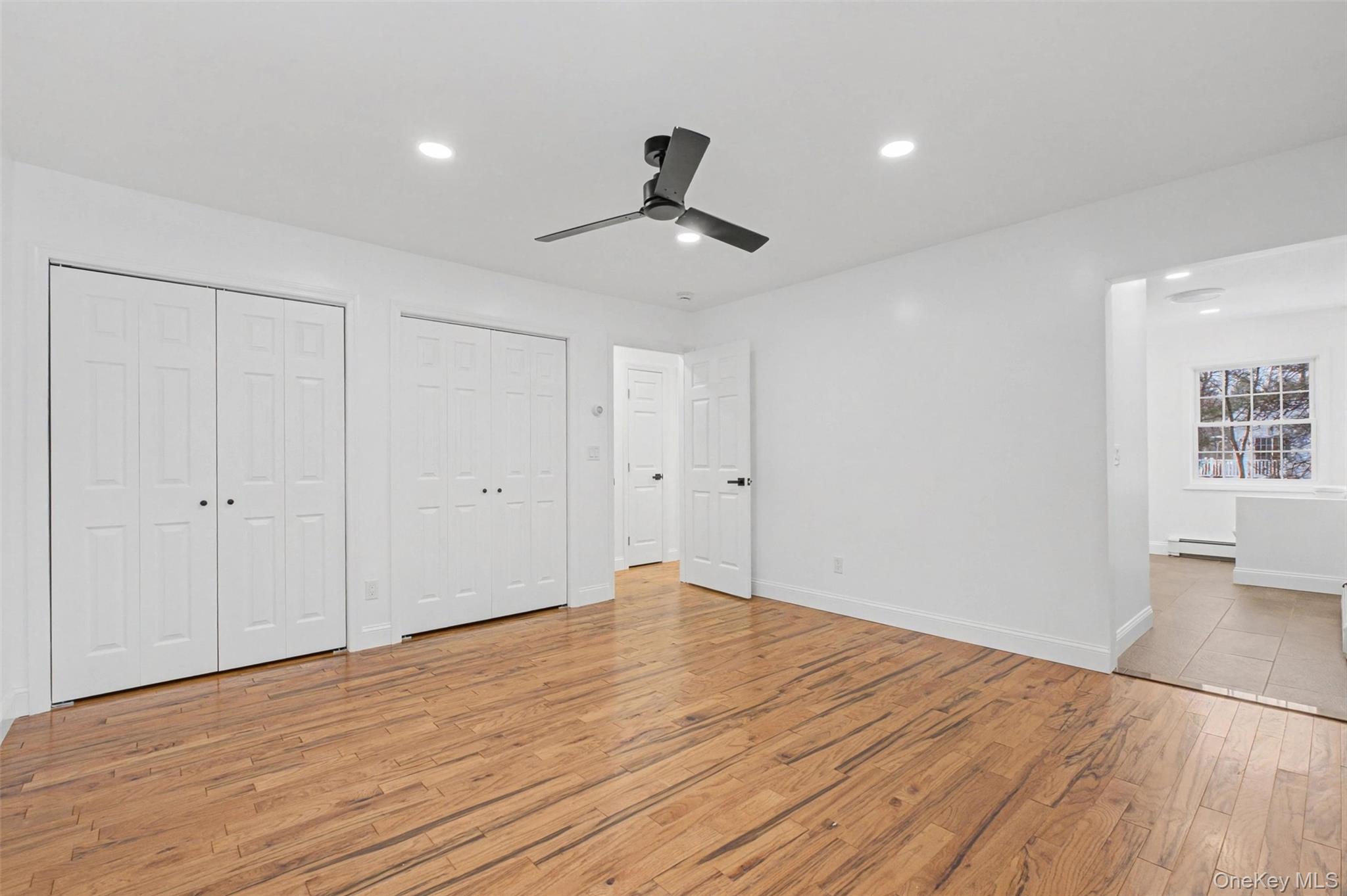 16 Cold Spring Road Putnam Valley, NY 10579 - Photo 22 of 44 a view of an empty room with wooden floor and windows