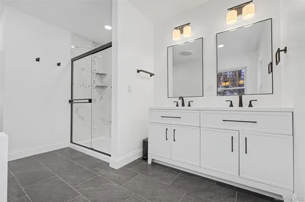 a bathroom with a double vanity sink mirror and