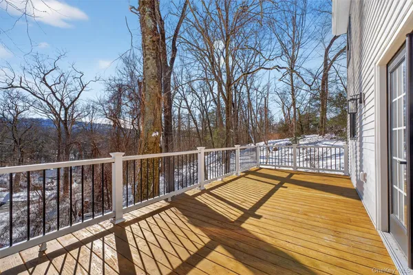 a view of a balcony with wooden floor and wooden fence