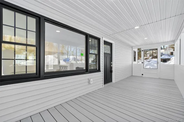 a view of a room with window and hardwood floor