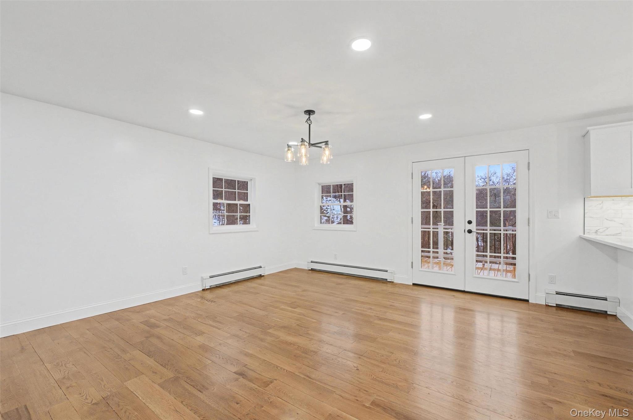 16 Cold Spring Road Putnam Valley, NY 10579 - Photo 8 of 44 an empty room with wooden floor and windows