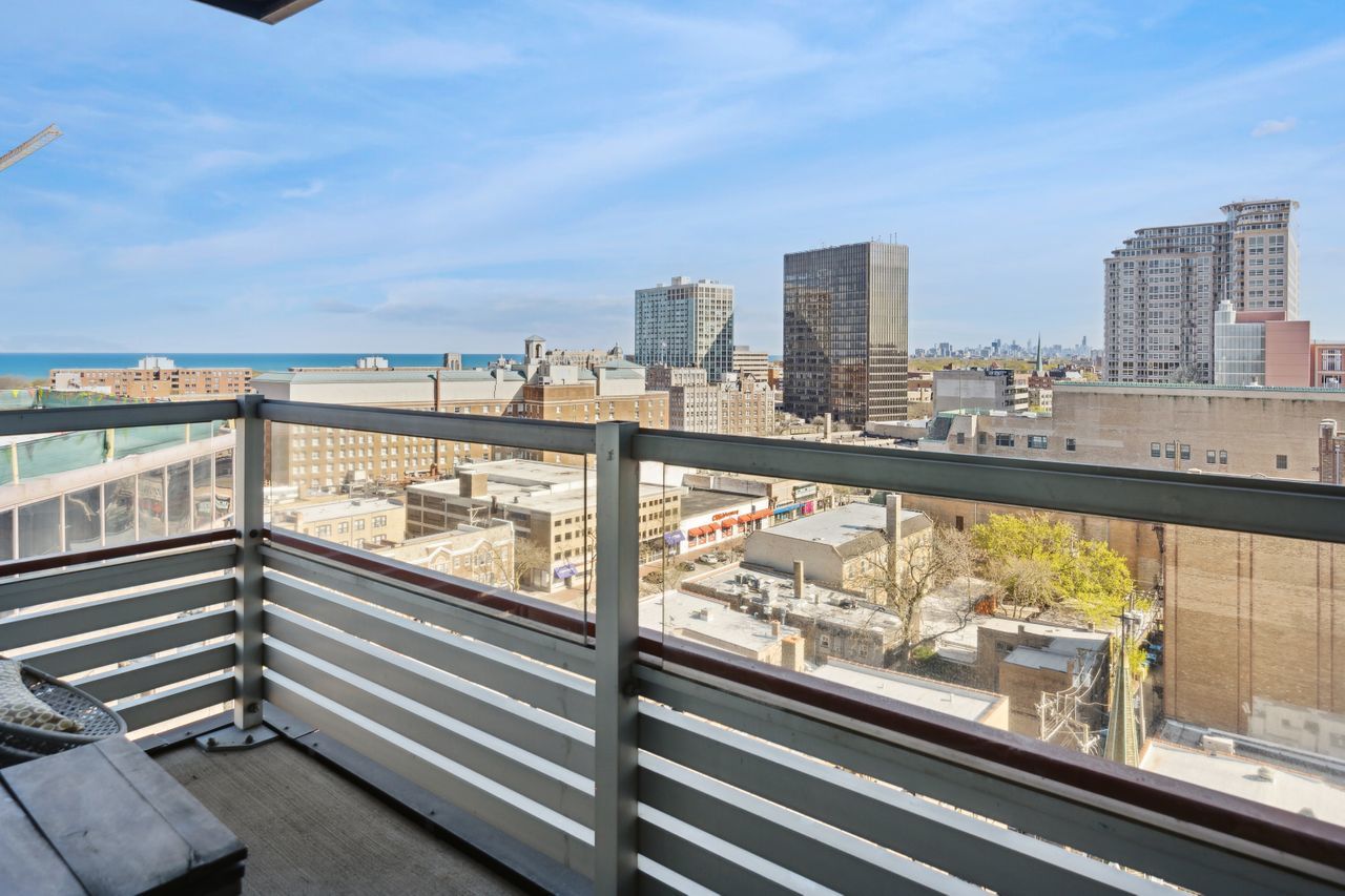 800 Elgin Road, Unit 1419 Evanston, IL 60201 - Photo 4 of 28 a view of a city from a balcony with furniture