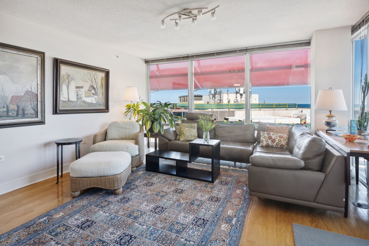 800 Elgin Road, Unit 1419 Evanston, IL 60201 - Photo 8 of 28 a living room with furniture and a large window