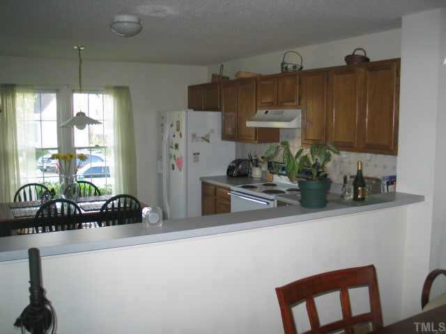 5409 Pennfine Drive Raleigh, NC 27610 - Photo 10 of 10 a kitchen with stainless steel appliances a sink a table and chairs