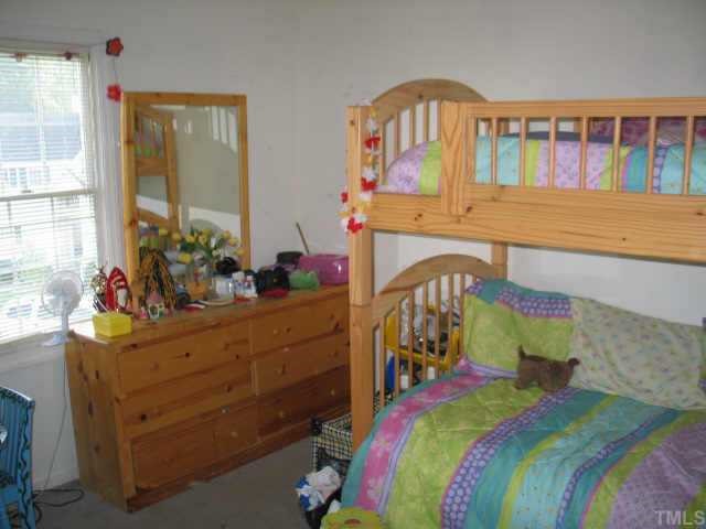 5409 Pennfine Drive Raleigh, NC 27610 - Photo 6 of 10 a bedroom with a bed table and a window