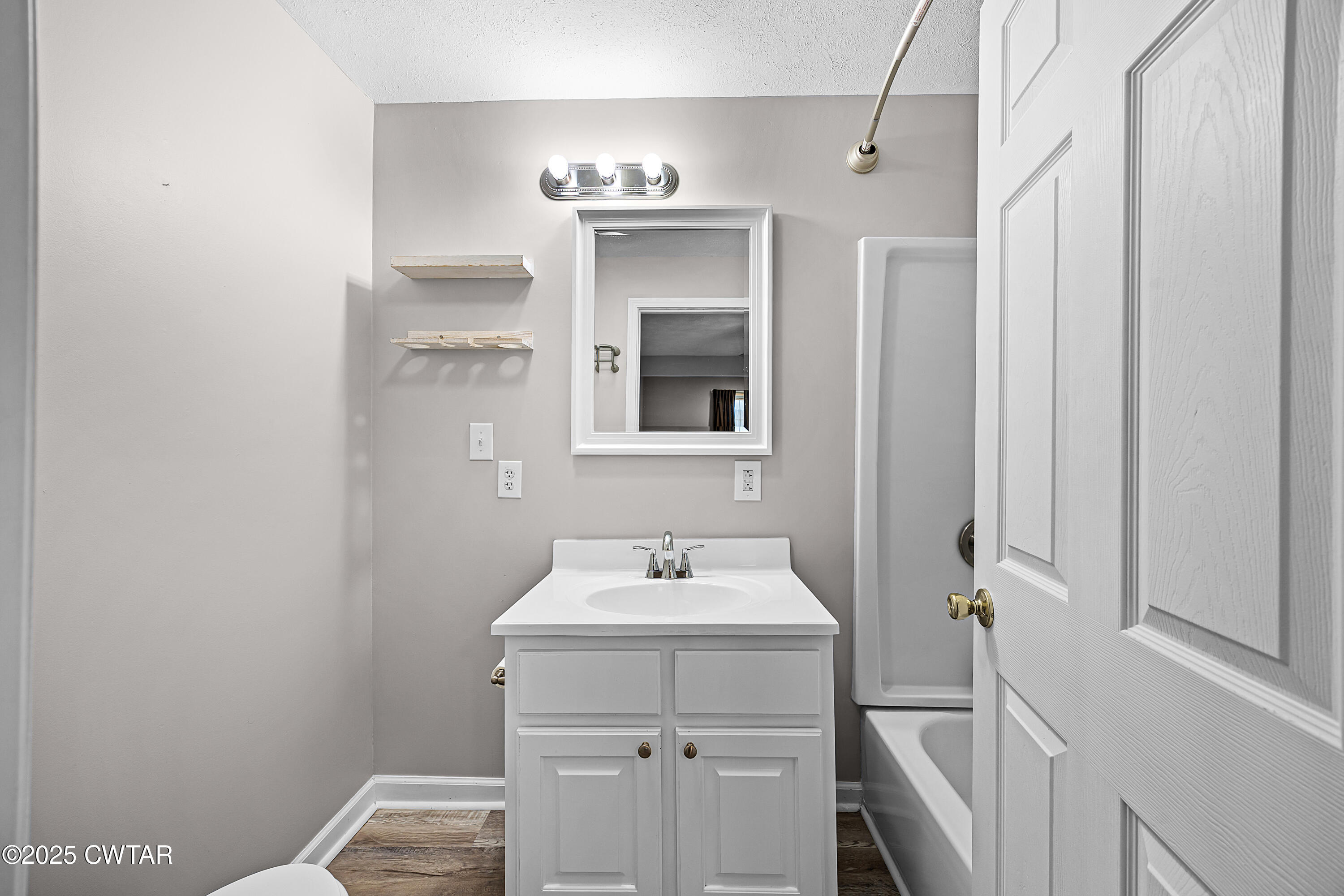462 Mifflin Avenue Henderson, TN 38340 - Photo 11 of 18 a bathroom with a sink and a mirror