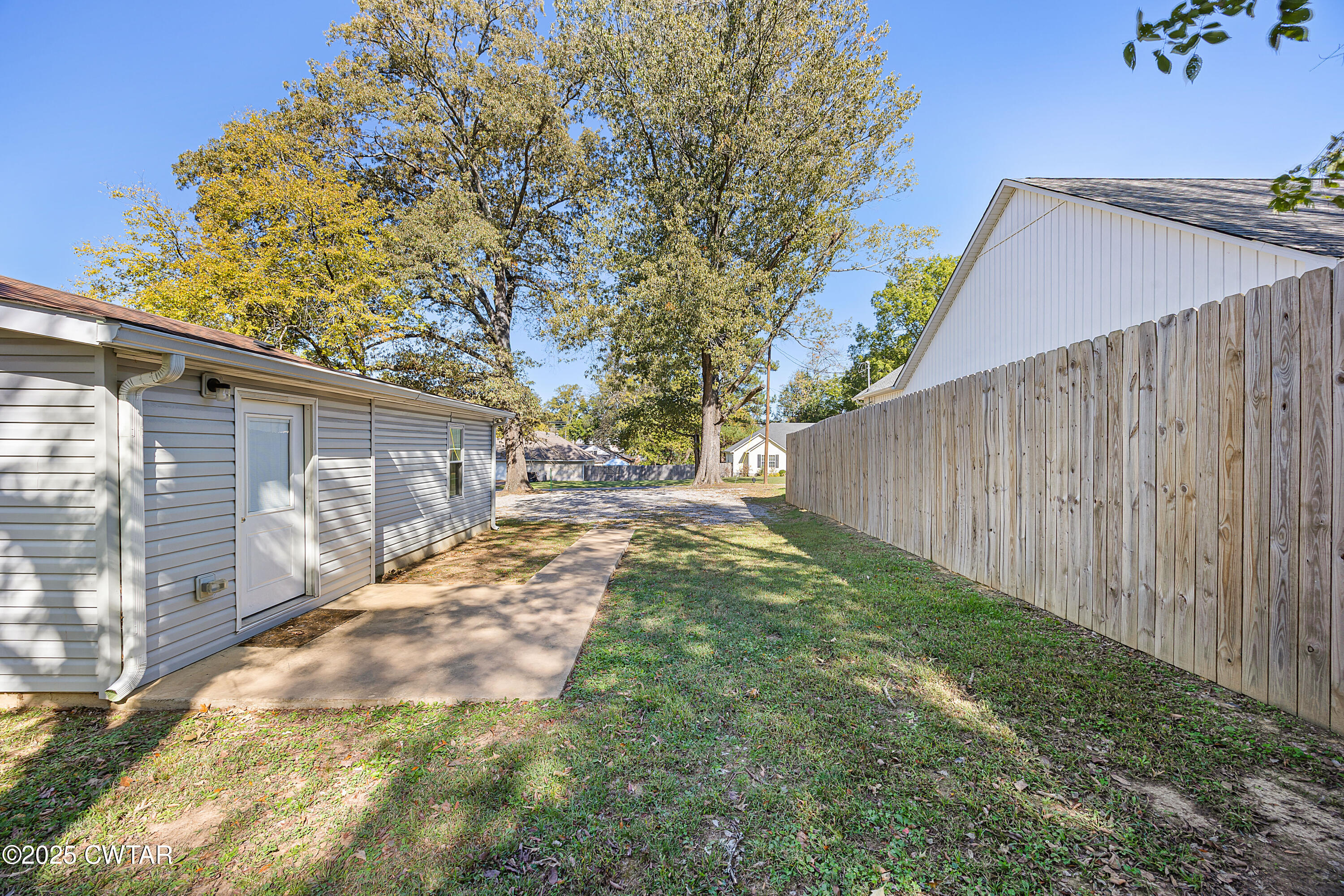 462 Mifflin Avenue Henderson, TN 38340 - Photo 17 of 18 a view of backyard with tree and wooden fence