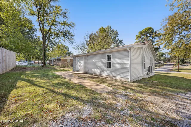 a view of a backyard with large tree